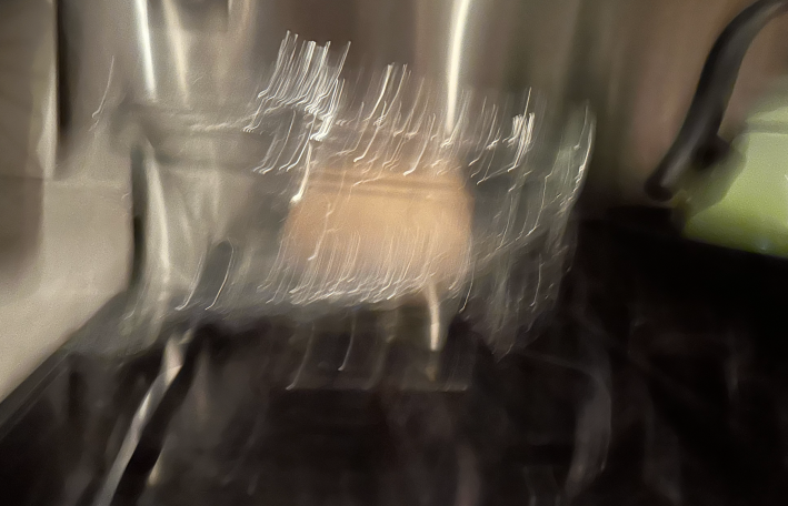 very blurry photo of some dough sitting on the stove