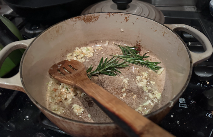 Rosemary and garlic in a pan on the stove.
