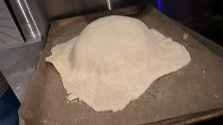 A big mound of dough on a baking sheet.