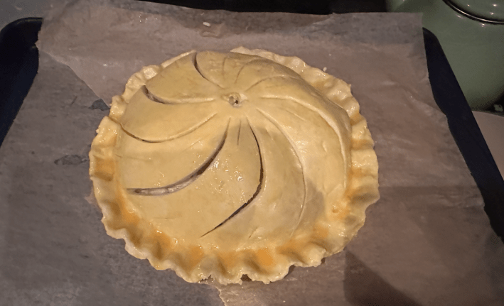 A pithivier with egg yolk on it.