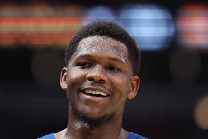 Anthony Edwards of the Minnesota Timberwolves, sweaty and smiling during a preseason game.