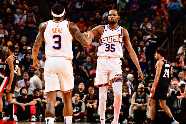 Bradley Beal and Kevin Durant of the Phoenix Suns, communicating during a preseason game.