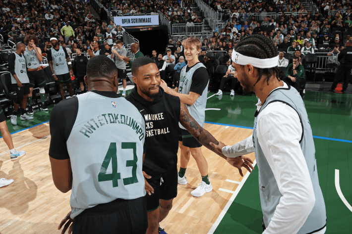 Damian Lillard of the Milwaukee Bucks greets teammates during introductions before a preseason game.