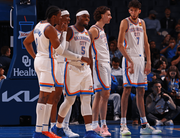 Luguentz Dort, Shai Gilgeous-Alexander, Chet Holmgren, and a couple other OKC Thunder guys, during a stop in play in a preseason game.
