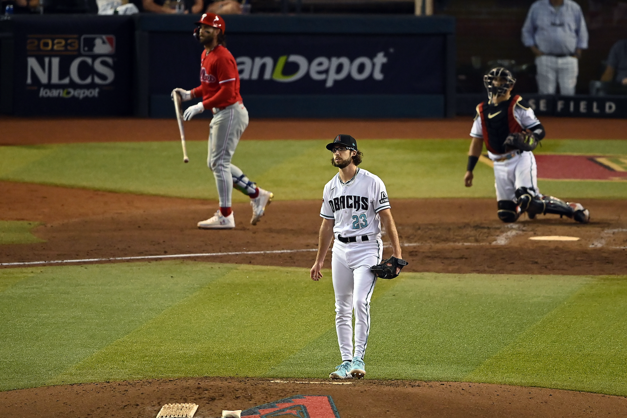Arizona's Zac Gallen and Philadelphia's Bryce Harper watch Harper's sixth-inning home run soar into the night during Philadelphia's 6-1 win in Game 5 of the NLCS.
