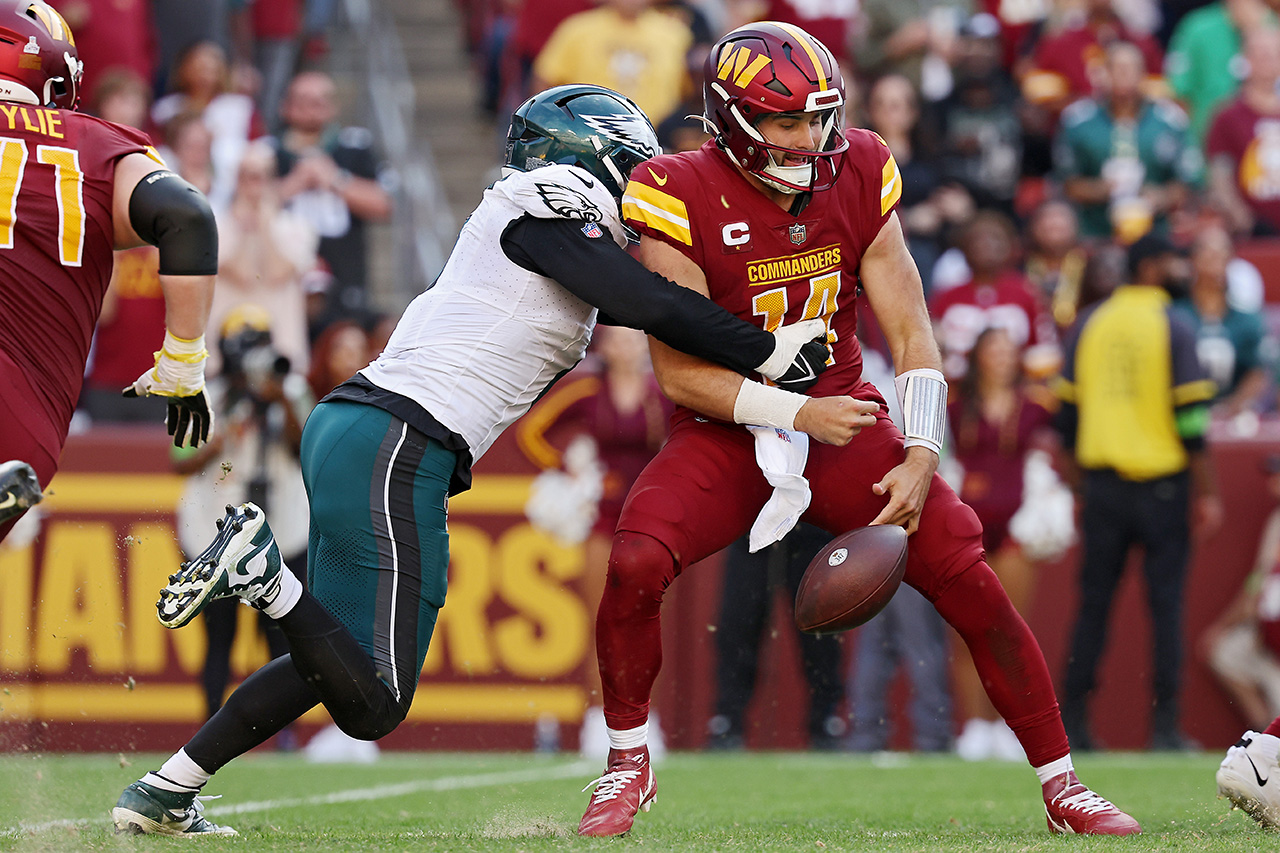 LANDOVER, MARYLAND - OCTOBER 29: Haason Reddick #7 of the Philadelphia Eagles forces Sam Howell #14 of the Washington Commanders to fumble in the fourth quarter at FedExField on October 29, 2023 in Landover, Maryland.