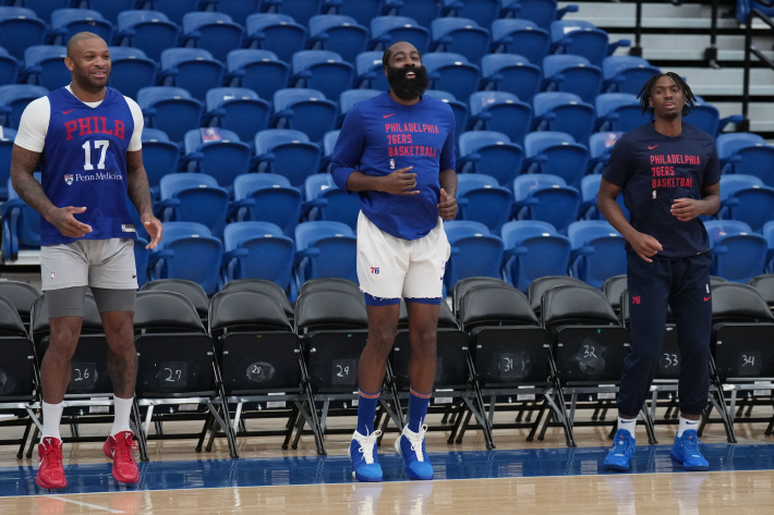 P.J. Tucker, James Harden, and Tyrese Maxey hop in place during a Philadelphia 76ers practice.