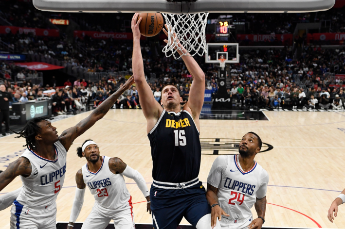 Nikola Jokic of the Denver Nuggets leaps to dunk against the Los Angeles Clippers in a preseason game.