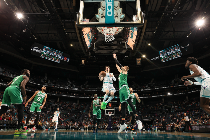 LaMelo Ball of the Charlotte Hornets goes up for a scoop layup against the Boston Celtics