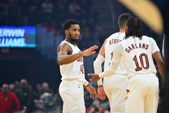 Donovan Mitchell and Darius Garland of the Cleveland Cavaliers slap five during a preseason game.