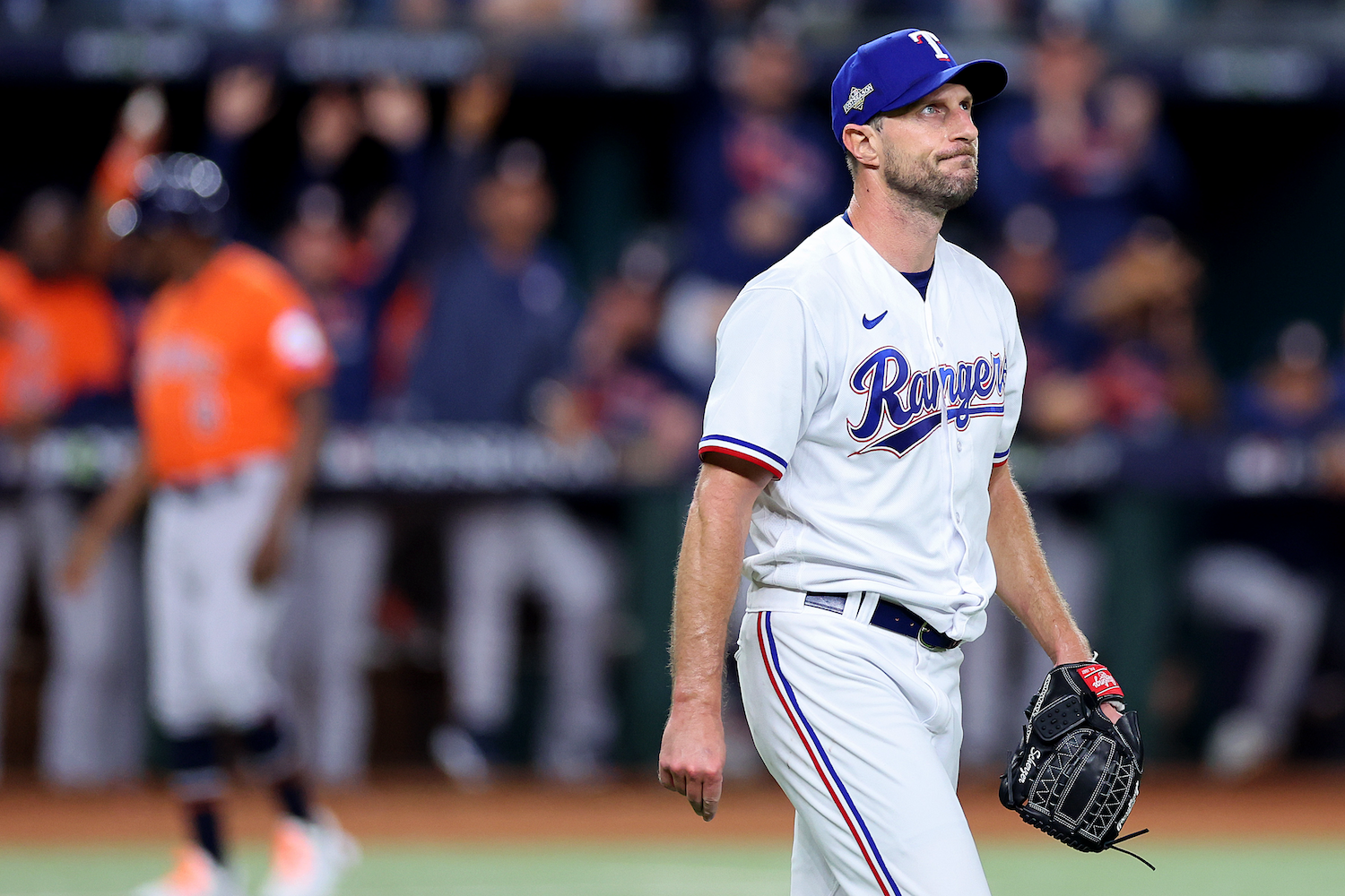 Max Scherzer of the Texas Rangers looks unhappy as he watches Jose Altuve's home run fly into the left-field stands.