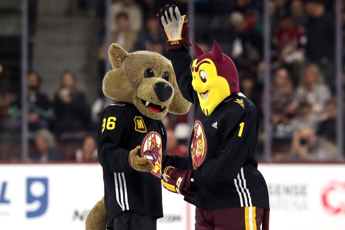 TEMPE, ARIZONA - APRIL 01: The Arizona Coyotes mascot, Howler, and Arizona State mascot, Sparky, drop the puck before the game between the San Jose Sharks and Arizona Coyotes at Mullett Arena on April 01, 2023 in Tempe, Arizona.