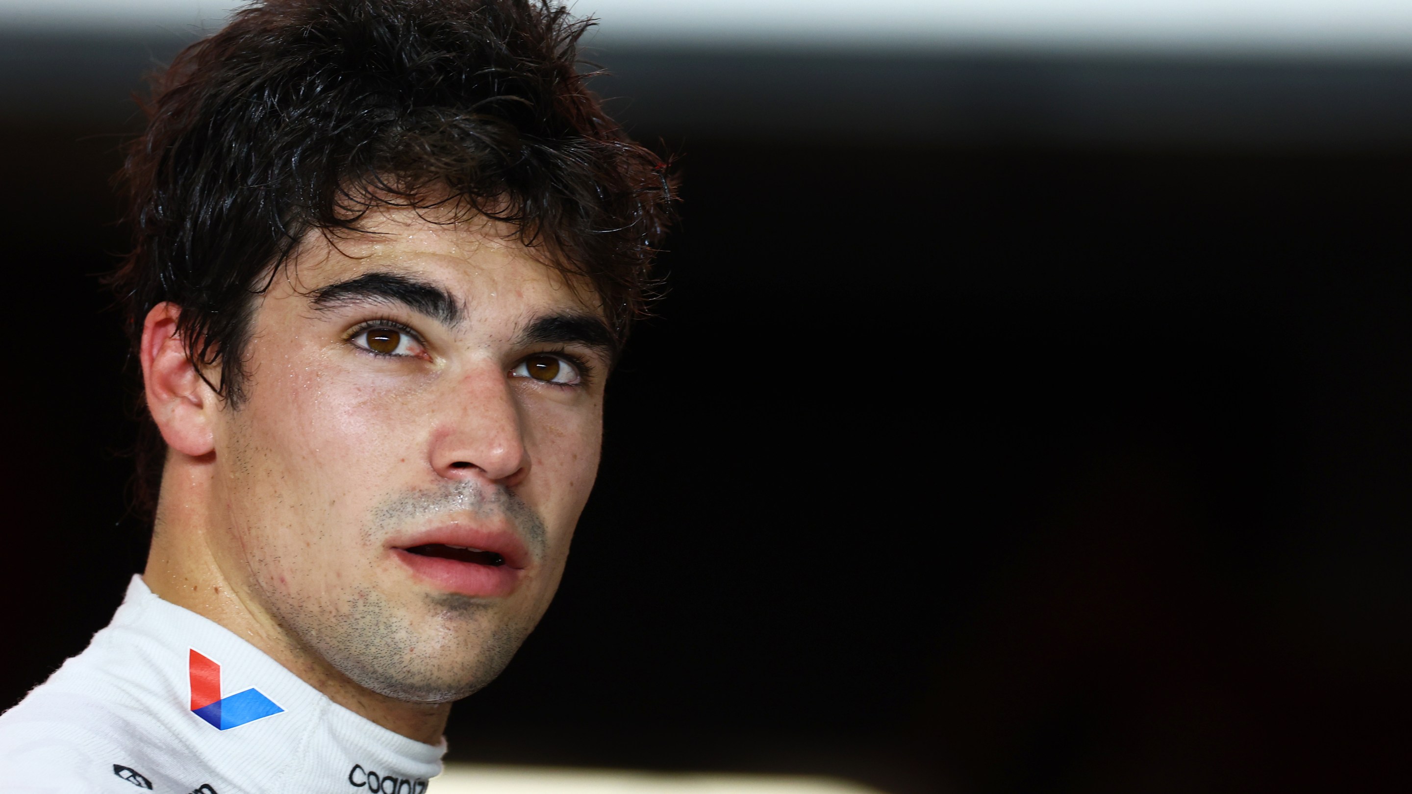 Lance Stroll of Canada and Aston Martin F1 Team looks on in the FIA garage during qualifying ahead of the F1 Grand Prix of Qatar.