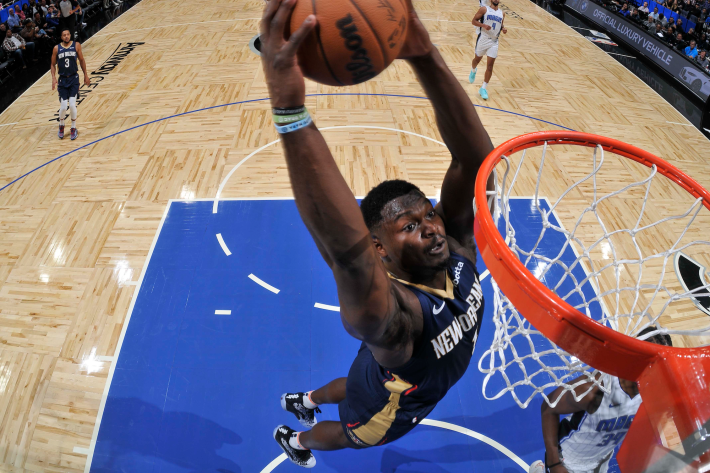 Zion Williamson of the New Orleans Pelicans rises for a slam dunk during a preseason game against the Orlando Magic.