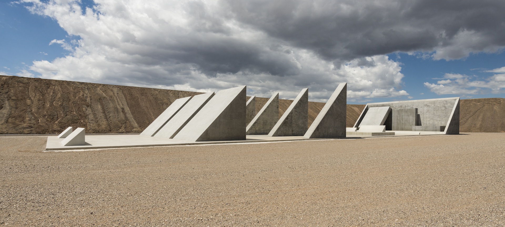 A collection of triangular shapes in Michael Heizer's City installation