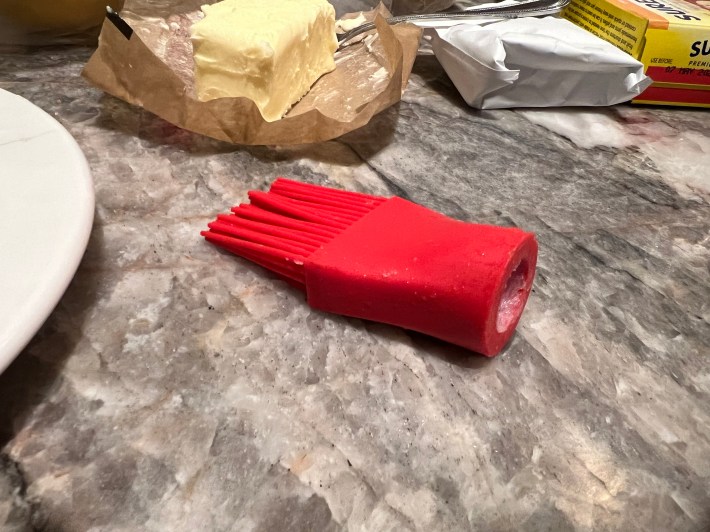 The red head of a destroyed silicone brush.