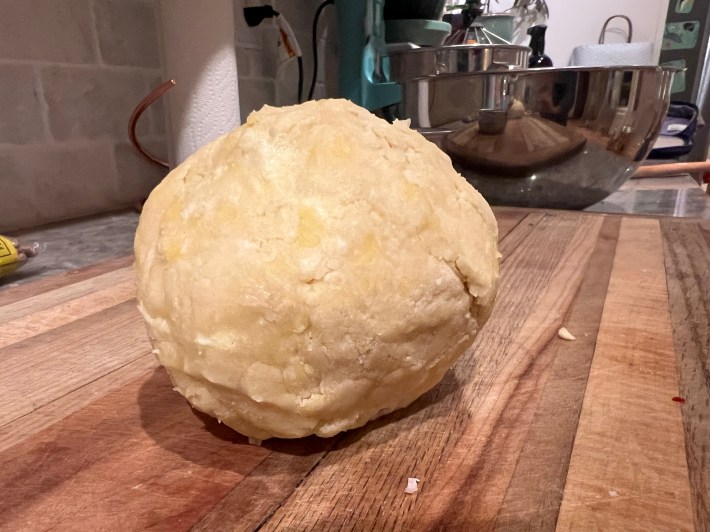 A ball of crumbly pie dough.