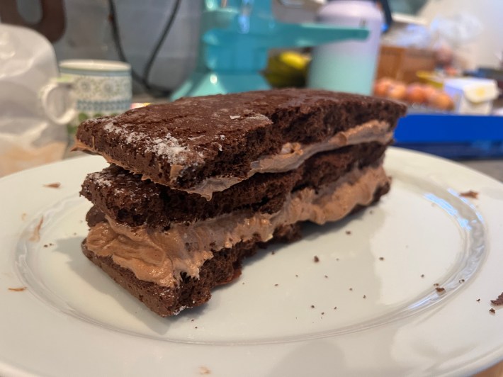 The strips of chocolate sponge arranged in layers and filled with buttercream.