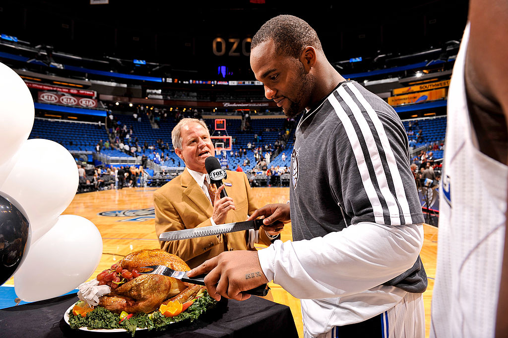 Glen Davis #11 of the Orlando Magic cuts a Thanksgiving turkey following his team's game against the Detroit Pistons on November 21, 2012 at Amway Center in Orlando, Florida.