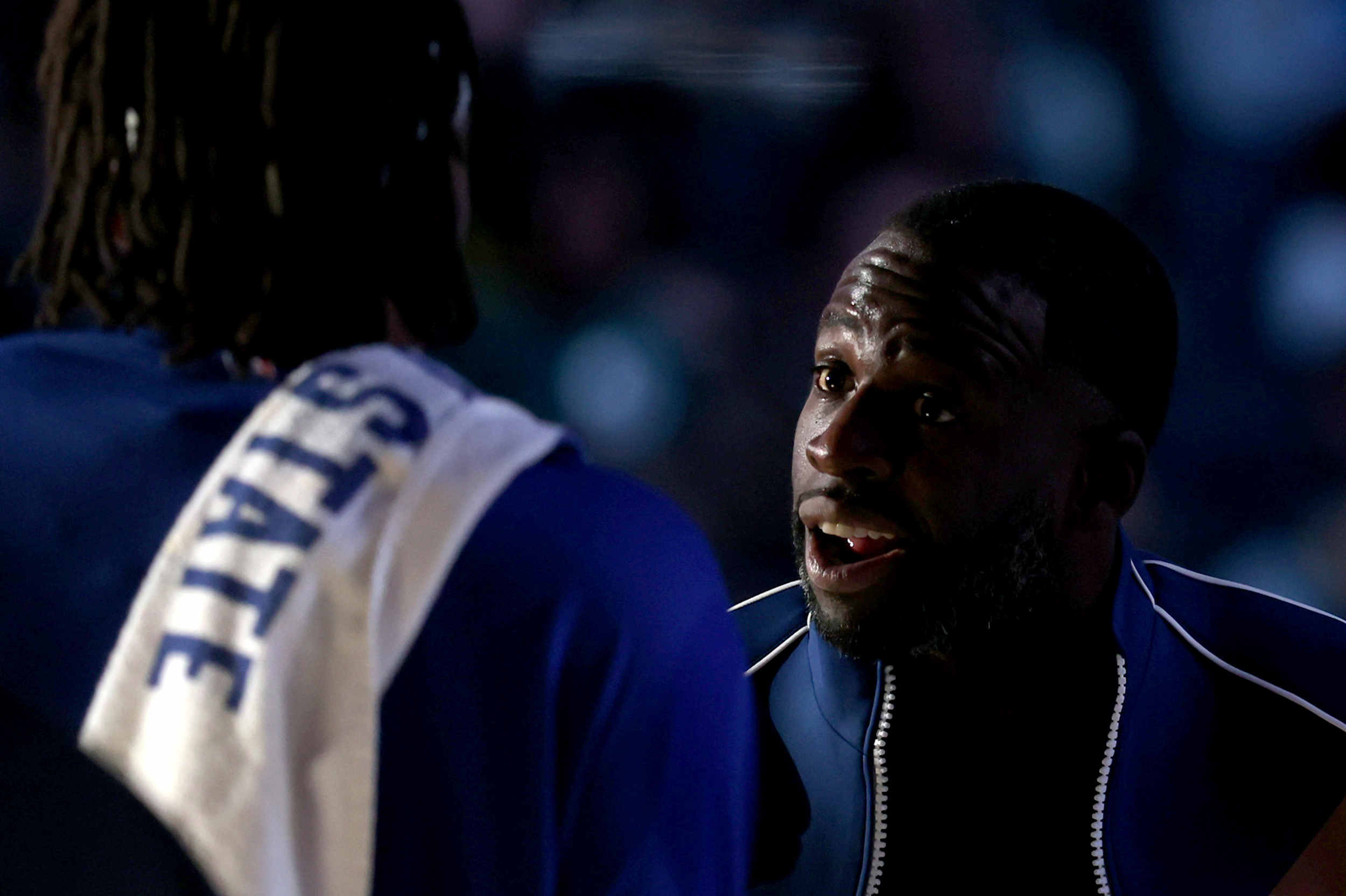 Draymond Green talks to a teammate during a timeout.
