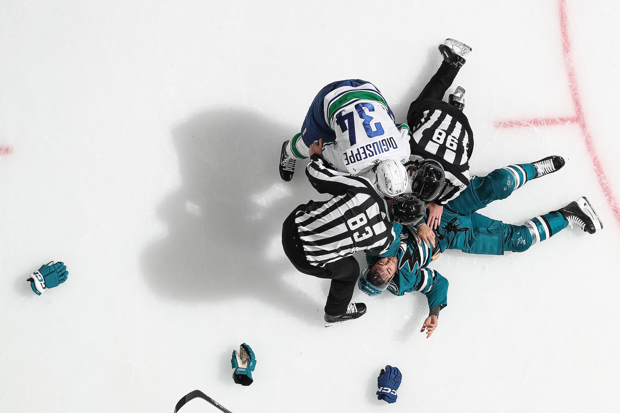 SAN JOSE, CA - NOVEMBER 2: An overhead view as Luke Kunin #11 of the San Jose Sharks fights against Phillip Di Giuseppe #34 of the Vancouver Canucks at SAP Center on November 2, 2023 in San Jose, California. (Photo by Kavin Mistry/NHLI via Getty Images)