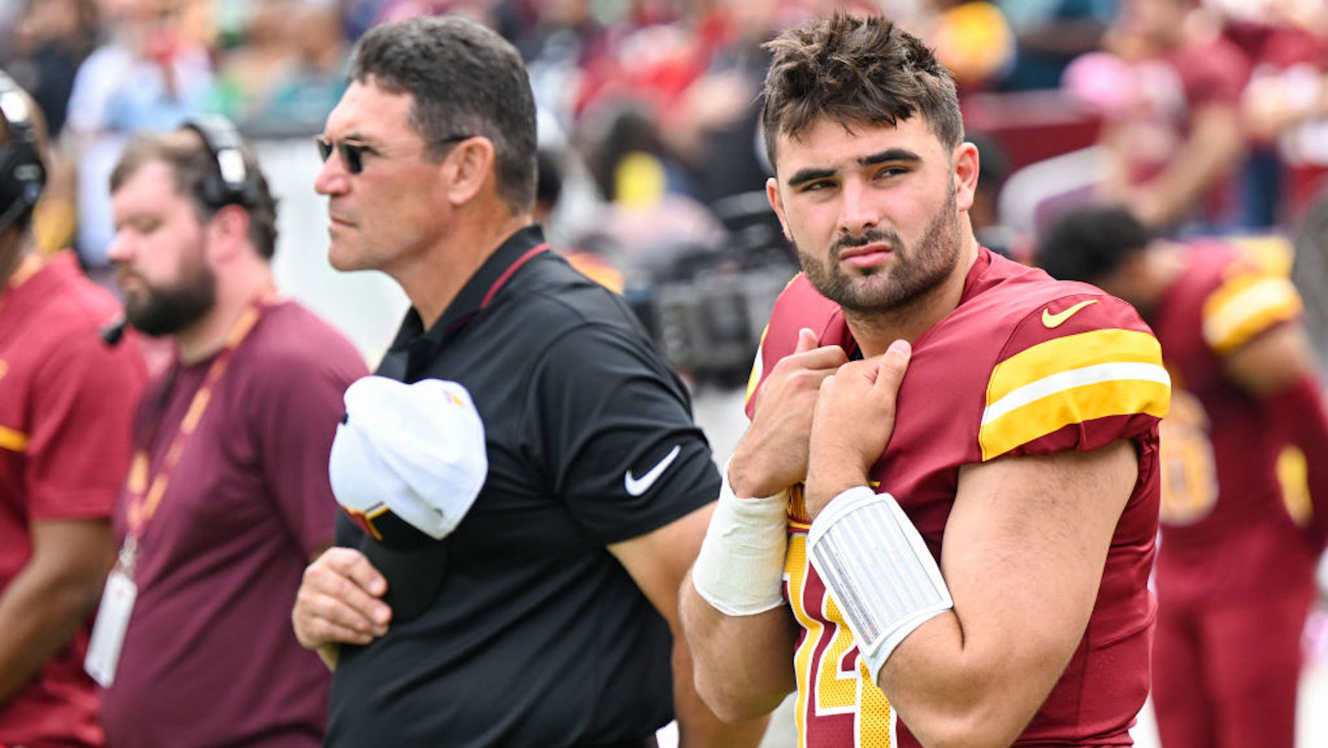 Washington Commanders quarterback Sam Howell (14) and head coach Ron Rivera stand for the national anthem prior to action against the Philadelphia Eagles at FedEx Field on October 29, 2023.