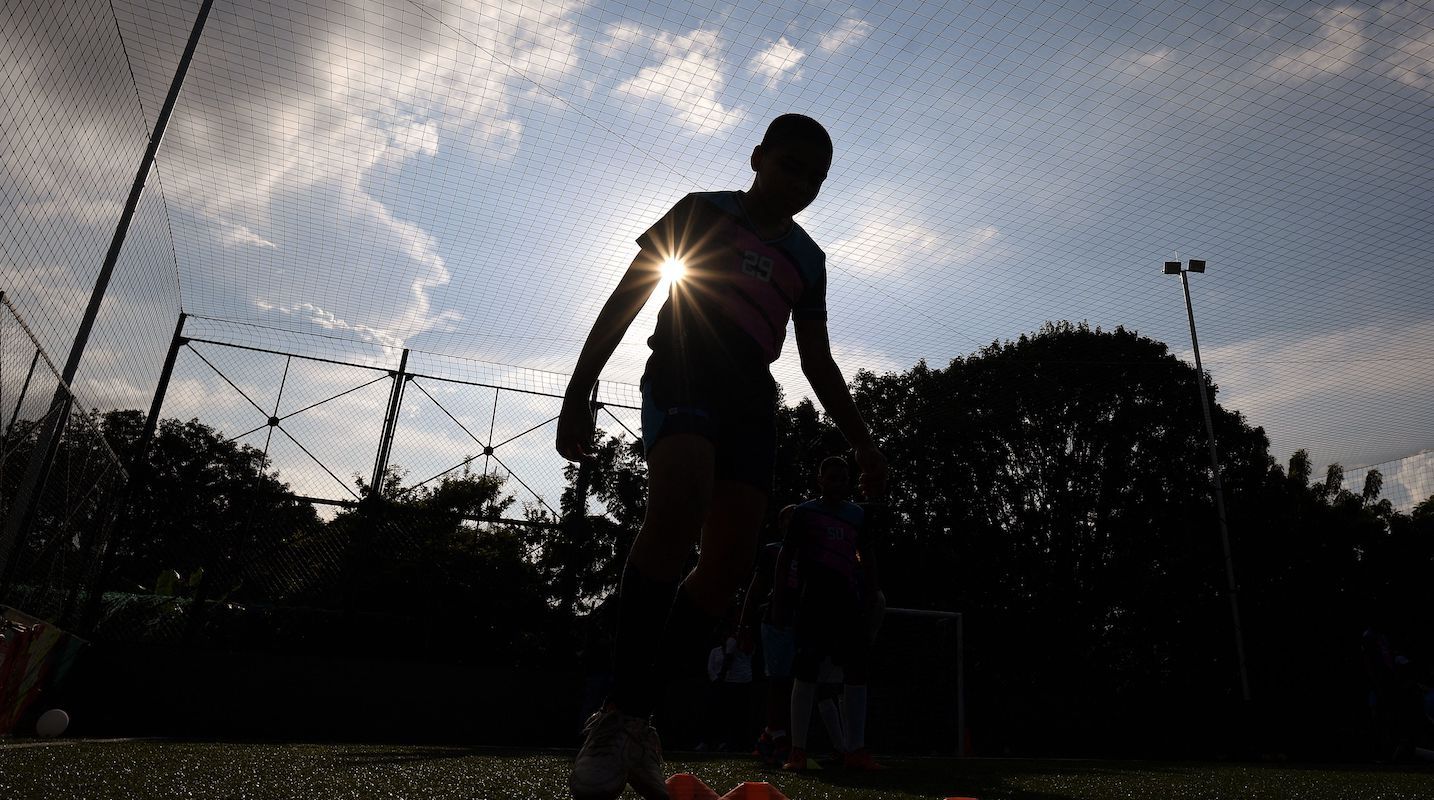 Silhouette of a child playing soccer
