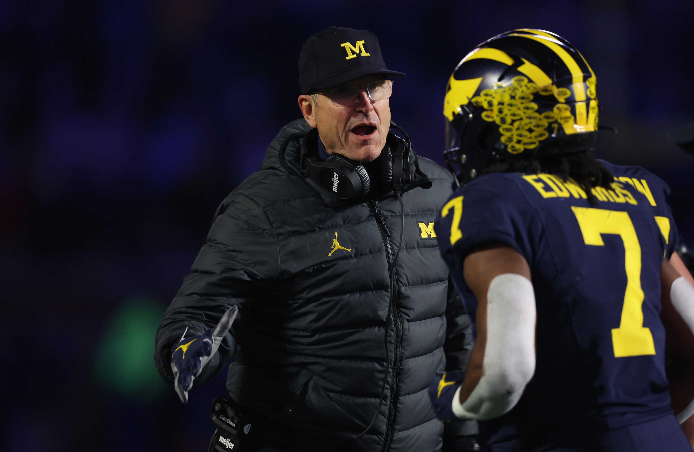 Michigan head coach Jim Harbaugh congratulates a player during his team's win over Purdue. Presumably everything was entirely aboveboard.