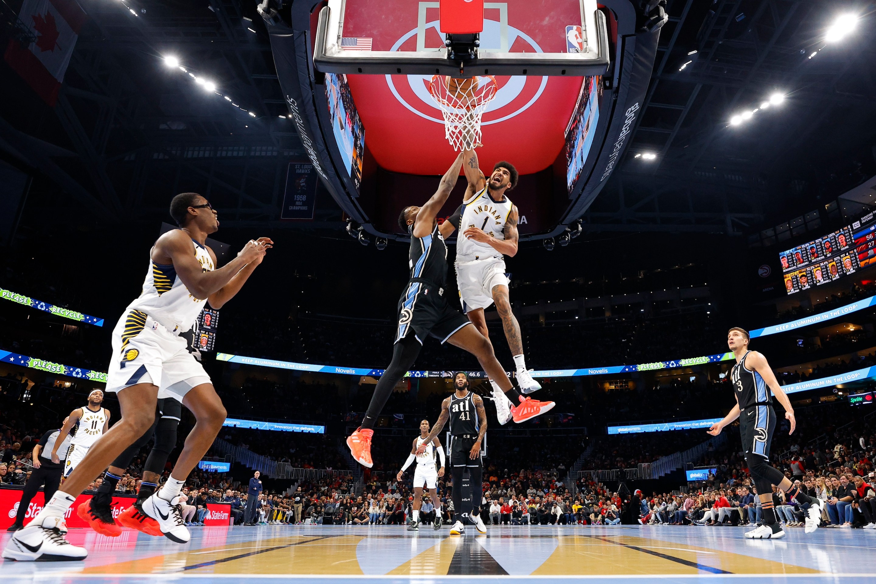 ATLANTA, GEORGIA - NOVEMBER 21: Obi Toppin #1 of the Indiana Pacers dunks against Onyeka Okongwu #17 of the Atlanta Hawks during the second quarter of an NBA In-Season Tournament game at State Farm Arena on November 21, 2023 in Atlanta, Georgia. NOTE TO USER: User expressly acknowledges and agrees that, by downloading and or using this photograph, User is consenting to the terms and conditions of the Getty Images License Agreement. (Photo by Todd Kirkland/Getty Images) *** Local Caption *** Obi Toppin; Onyeka Okongwu