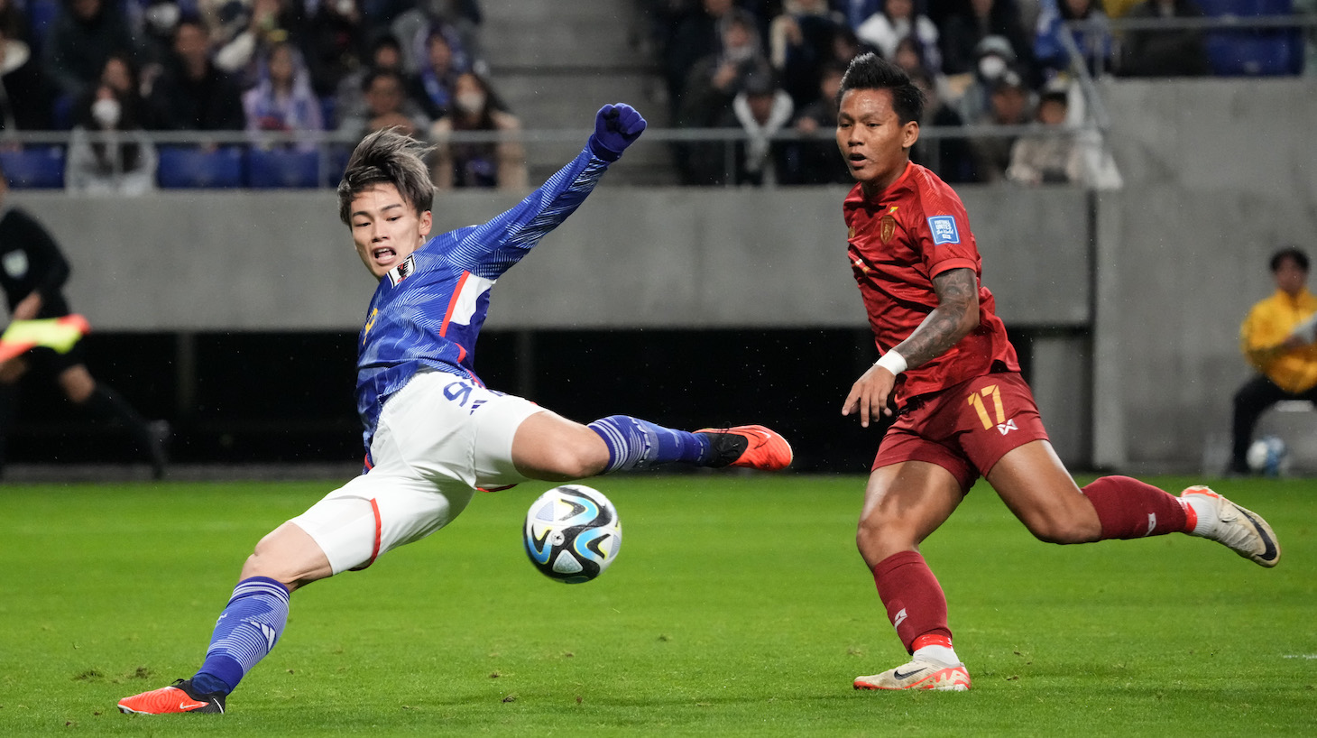 Ayase Ueda of Japan controls the ball against Thet Hein Soe of Myanmar during the FIFA World Cup Asian 2nd qualifier match between Japan and Myanmar at Panasonic Stadium Suita on November 16, 2023 in Suita, Osaka, Japan.