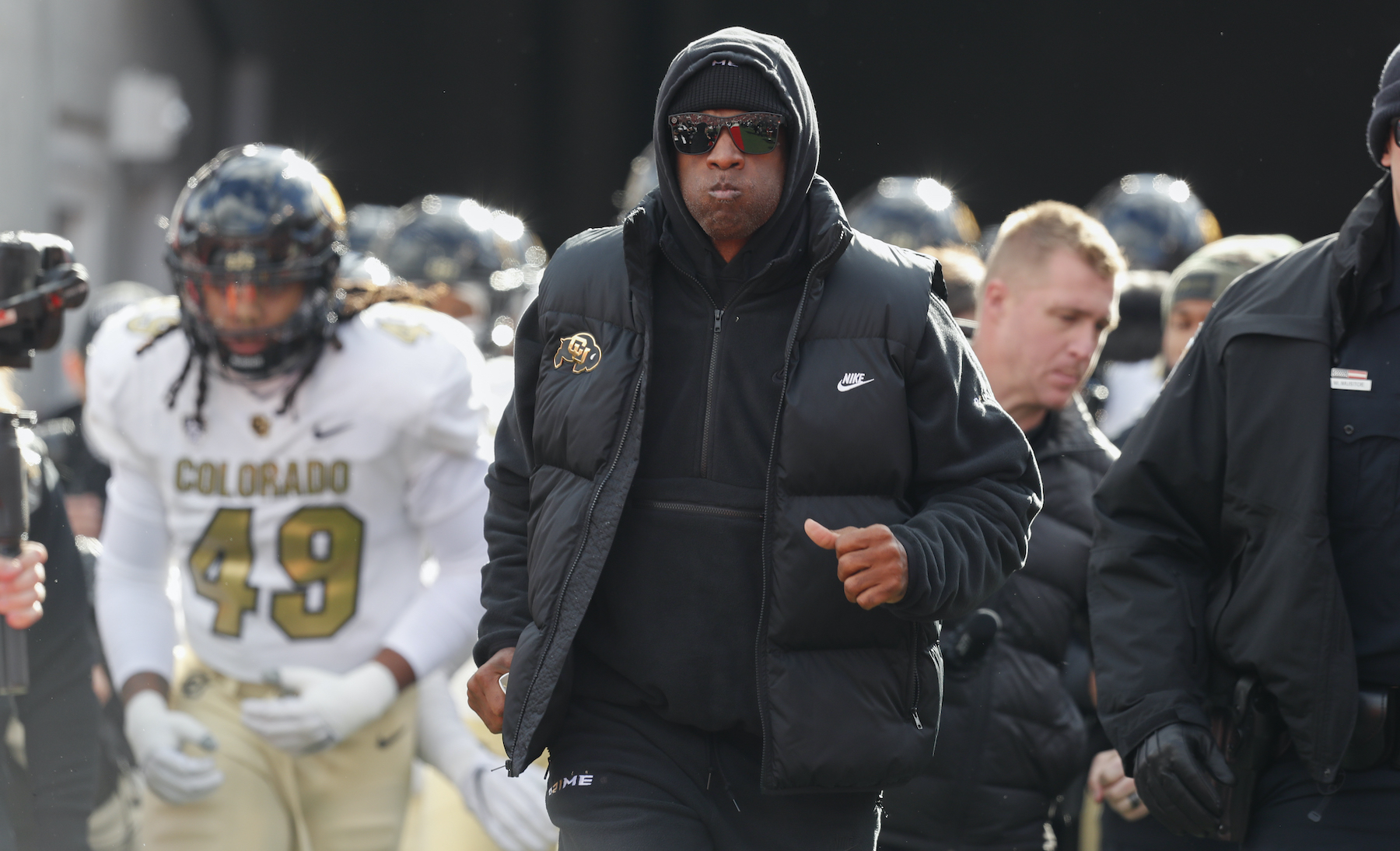 Deion Sanders jogs onto the field with the Colorado Buffaloes