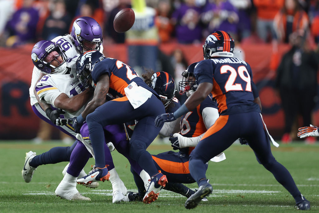 Quarterback Joshua Dobbs #15 of the Minnesota Vikings fumbles the football after being hit by safety Kareem Jackson #22 of the Denver Broncos during the first quarter of the NFL game at Empower Field At Mile High on November 19, 2023 in Denver, Colorado.