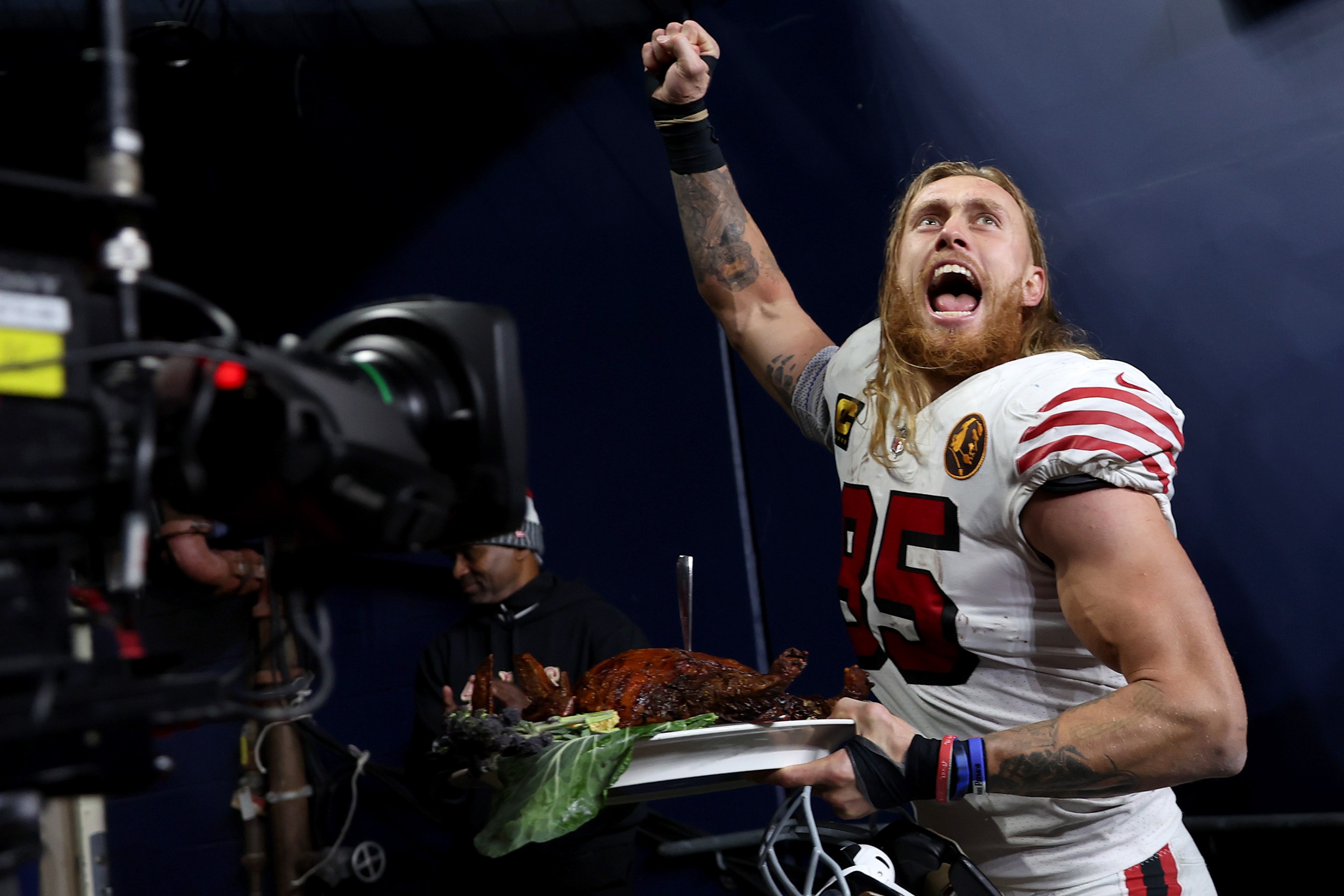 SEATTLE, WASHINGTON - NOVEMBER 23: George Kittle #85 of the San Francisco 49ers walks off the field with a turkey after beating the Seattle Seahawks 31-13 at Lumen Field on November 23, 2023 in Seattle, Washington. (Photo by Steph Chambers/Getty Images)