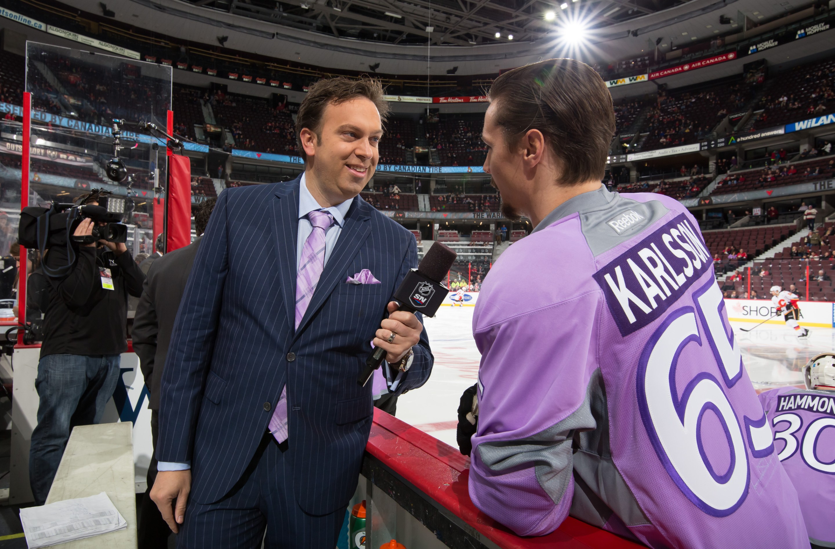 OTTAWA, ON - OCTOBER 28: Elliotte Friedman interview Erik Karlsson #65 of the Ottawa Senators on Hockey Fights Cancer night prior to a game against the Calgary Flames at Canadian Tire Centre on October 28, 2015 in Ottawa, Ontario, Canada. (Photo by Andre Ringuette/NHLI via Getty Images)