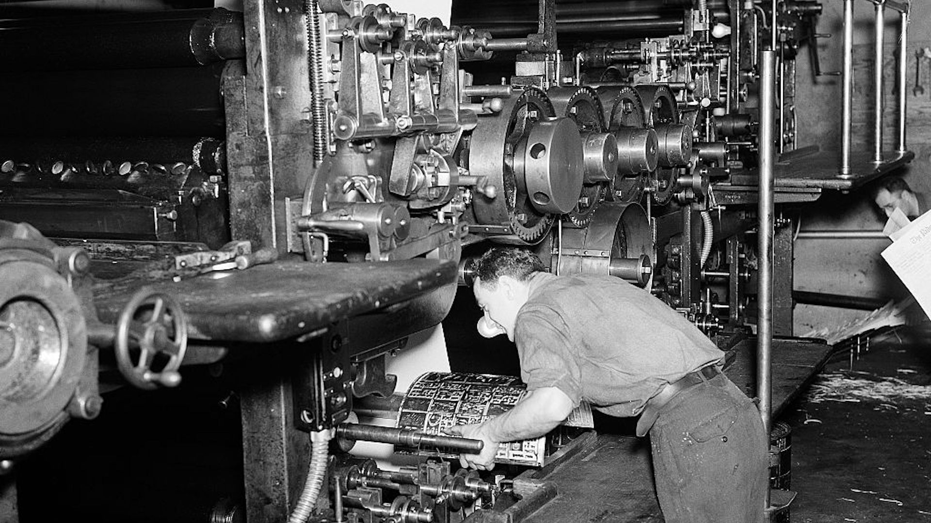 (Original Caption) Ridgewood, NJ-: Attaching one of the plates (stereotype) to a cylinder on a medium size newspaper press. Ca. 1940s-1950s.