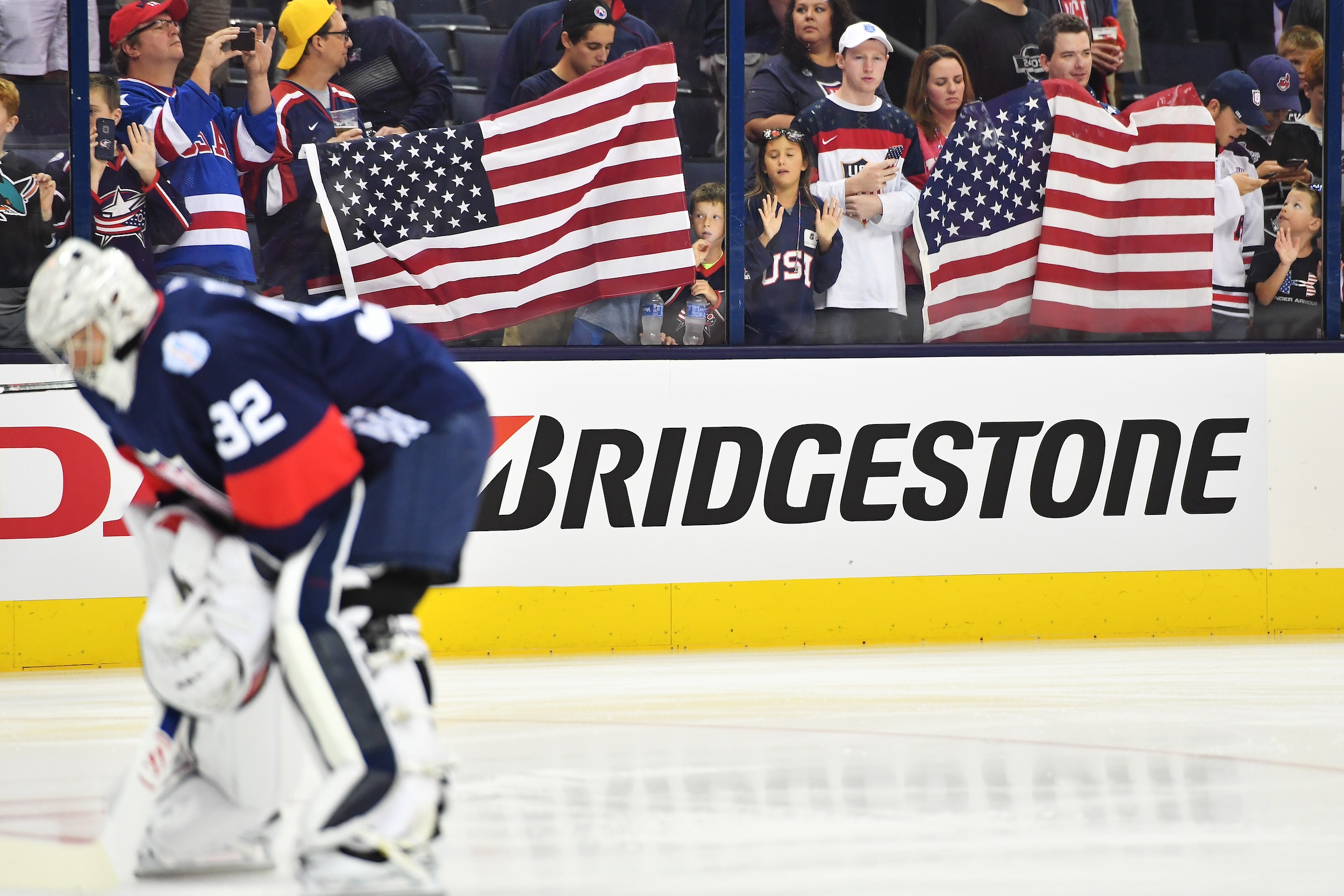 Fans display American flag during warmups prior to an exhibition game between Team USA and Team Canada on September 9, 2016 at Nationwide Arena in Columbus, Ohio. (Photo by Jamie Sabau/World Cup of Hockey via Getty Images)