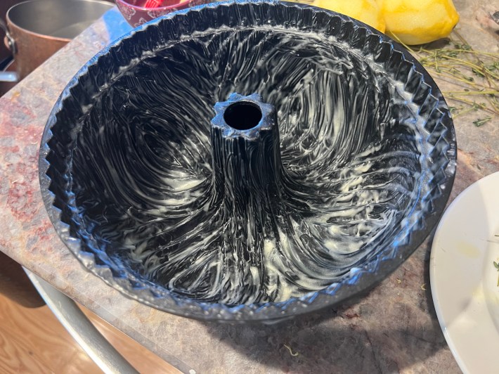 A bundt tin greased all over with melted butter.