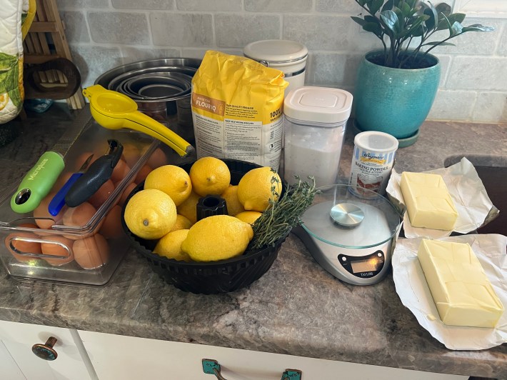 Bundt cake ingredients organized on Chris's countertop: Butter, flour, sugar, lemons, thyme, eggs, baking powder.