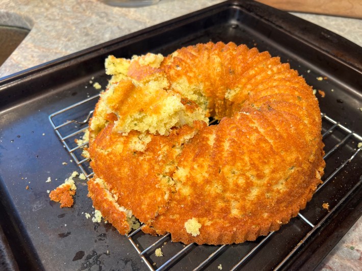 The entire left side of this bundt cake has collapsed and crumbled away, and an effort to rebuild it has fallen well short of success.