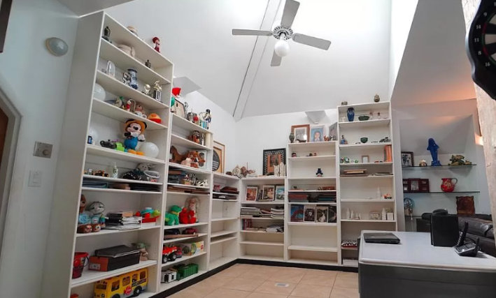 all white room with bookshelves