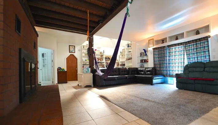 a hammock hanging in the middle of a living room