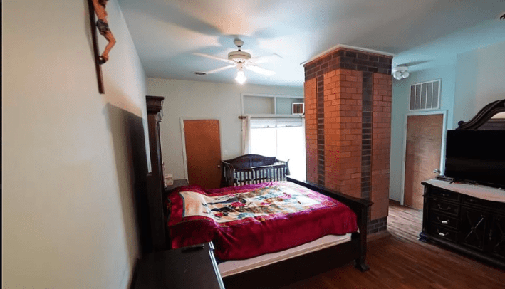 bedroom with giant pillar in the middle of it