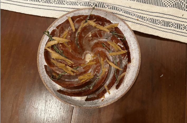 A bundt cake from above with melted icing.