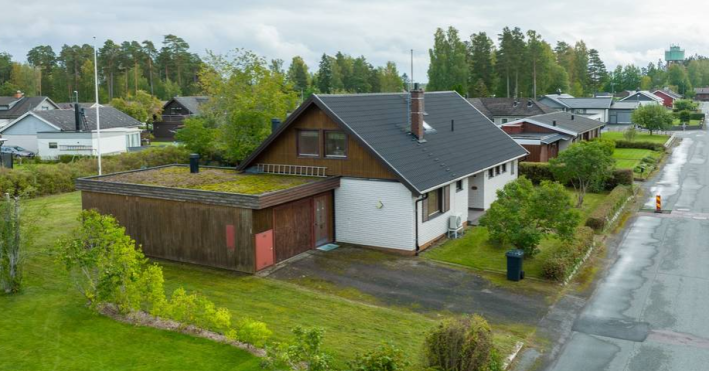 small white house with wooden addition