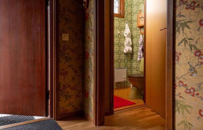 hallway with green toilet