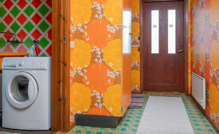 hallway with beautiful marigold wallpaper and tile floor