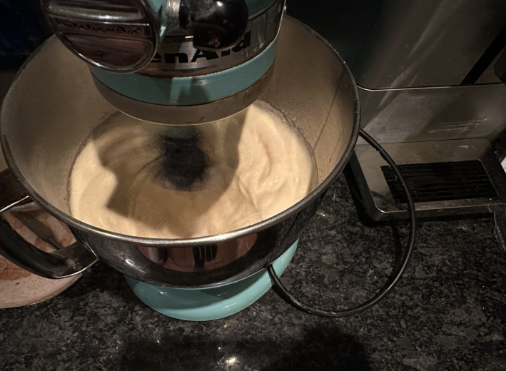 A stand-mixer whipping some eggs.