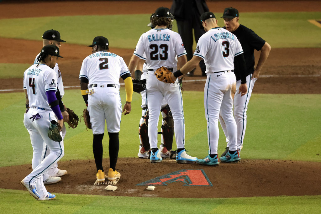 Pitching coach Brent Strom meets with Zac Gallen during Game Five of the World Series.