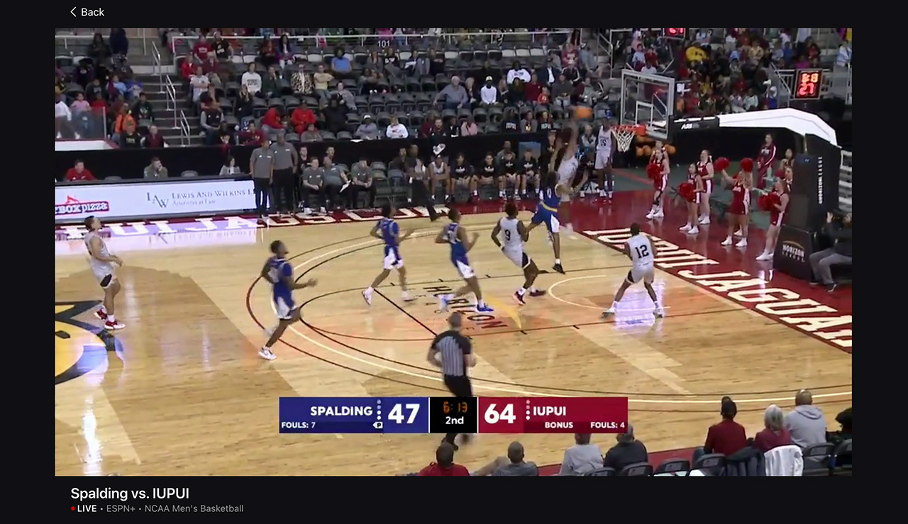 A screenshot on ESPN+ of a player from IUPUI going up for a dunk, you can see the surrounding