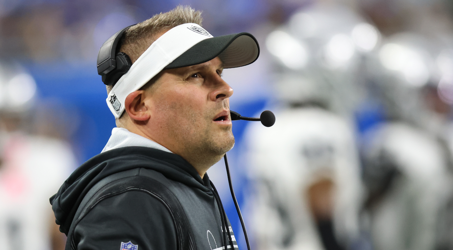 Las Vegas Raiders head coach Josh McDaniels stands there looking like a stupid asshole in his visor and headset.